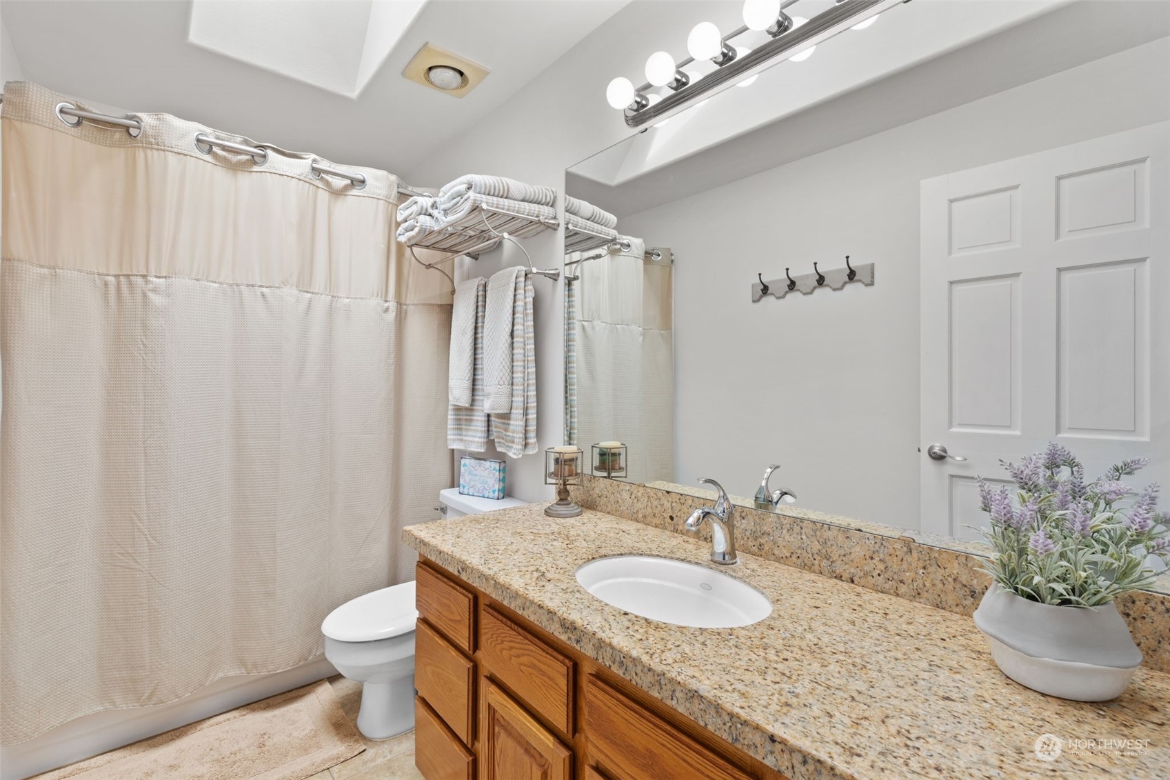 5122 Northeast 17th Street Renton, WA 98059 - Photo 28 of 35 a bathroom with a granite countertop sink a toilet and a mirror