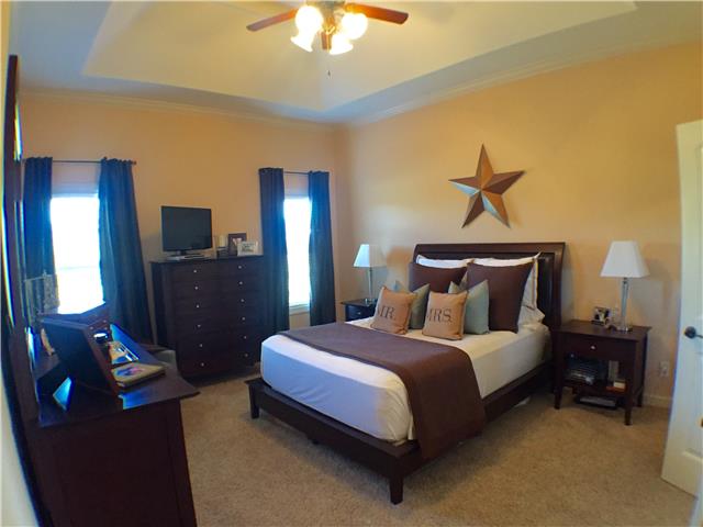 525 Sugar Flat Road Lebanon, TN 37087 - Photo 14 of 20 a spacious bedroom with a bed and a chandelier