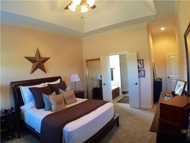 525 Sugar Flat Road Lebanon, TN 37087 - Photo 16 of 20 a bed room with a bed and a chandelier
