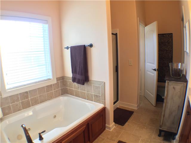 525 Sugar Flat Road Lebanon, TN 37087 - Photo 20 of 20 a bathroom with a bathtub and a shower