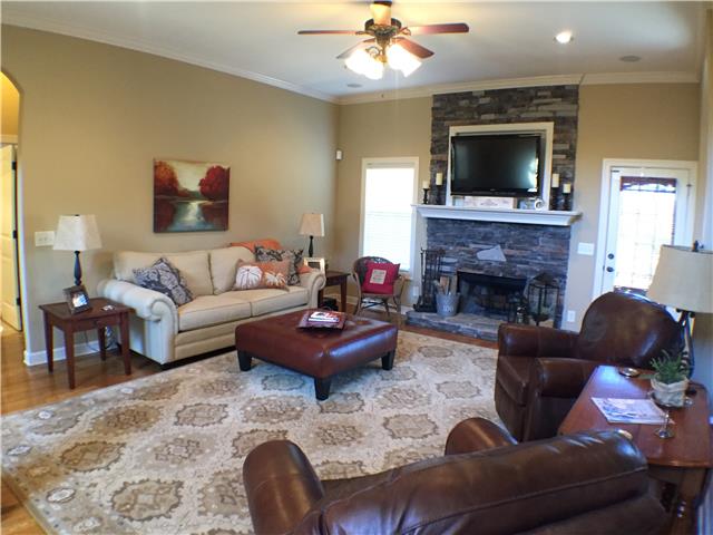 525 Sugar Flat Road Lebanon, TN 37087 - Photo 2 of 20 a living room with furniture a flat screen tv and a fireplace