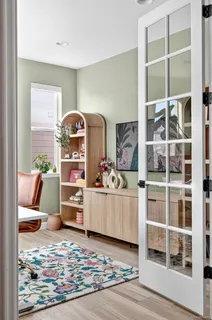 a kitchen with stainless steel appliances a dining table chairs stove refrigerator and cabinets