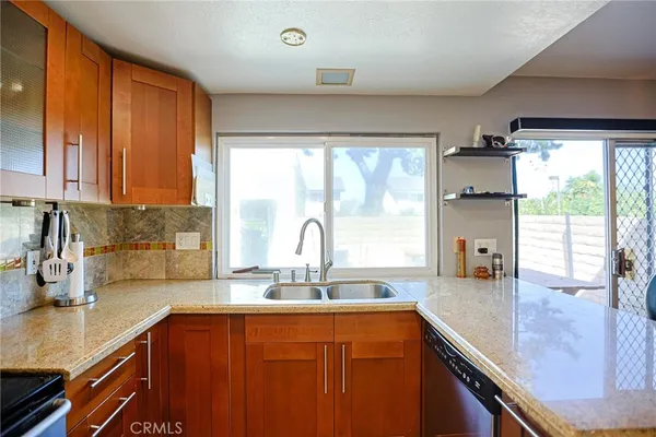a kitchen with stainless steel appliances granite countertop sink stove and cabinets