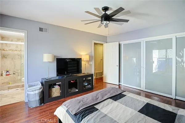 a bedroom with a bed and a flat screen tv