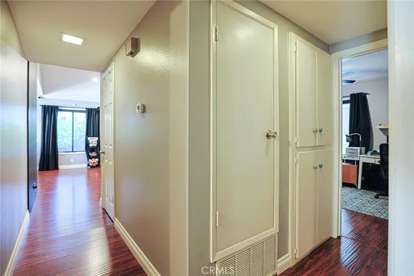 a view of a hallway with wooden floor