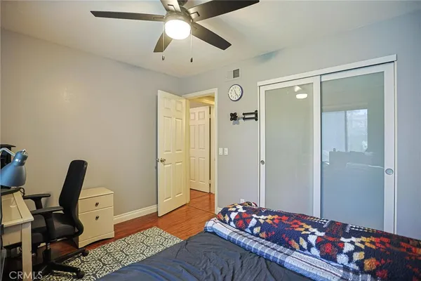 a bedroom with a bed and wooden floor