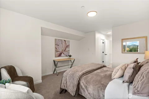 a bedroom with a bed and a painting on the wall