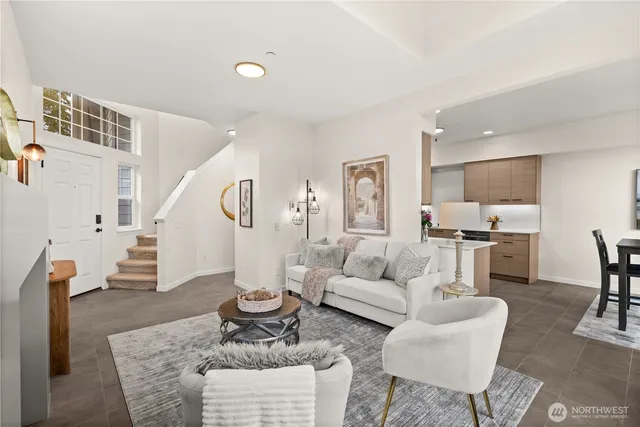 a living room with furniture and kitchen view