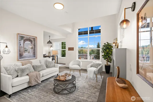 a living room with furniture a large window and a table