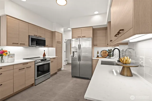 a kitchen with stainless steel appliances granite countertop a sink and a stove
