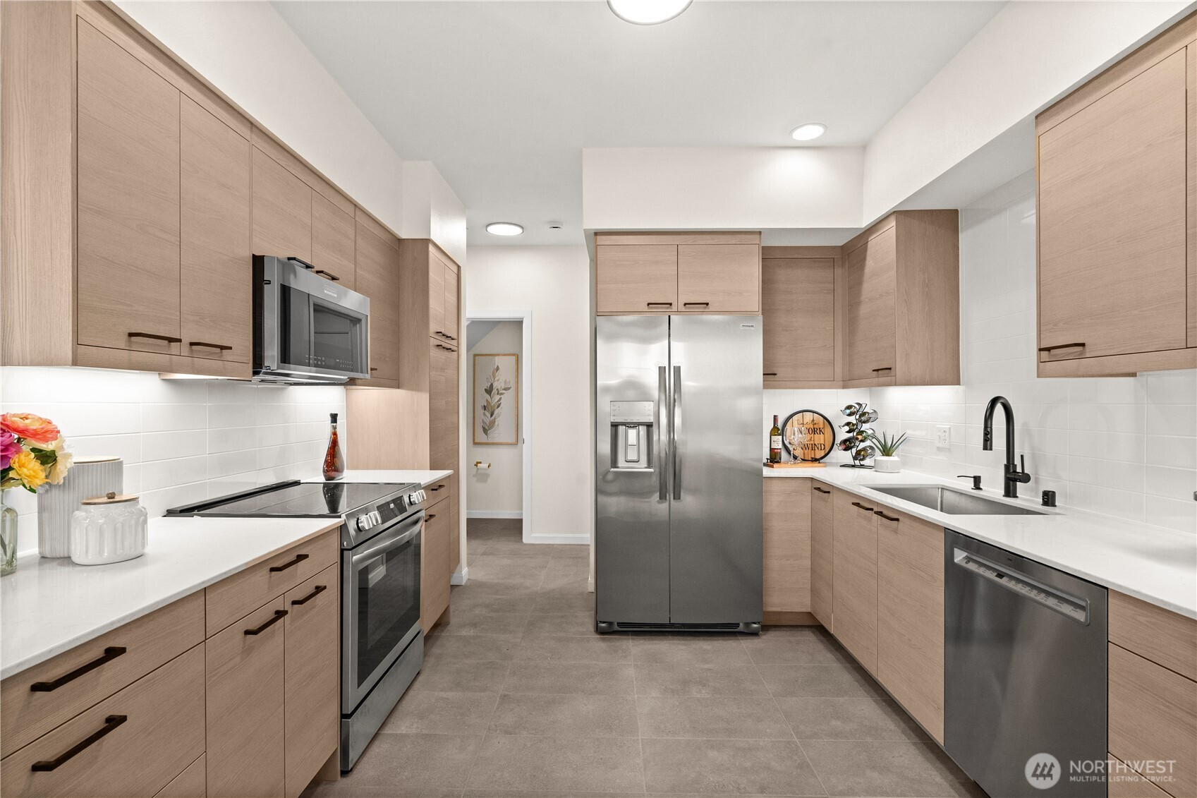 23202 Fitzgerald Road, Unit 2 Bothell, WA 98021 - Photo 7 of 20 a kitchen with stainless steel appliances granite countertop a sink a stove a refrigerator and cabinets