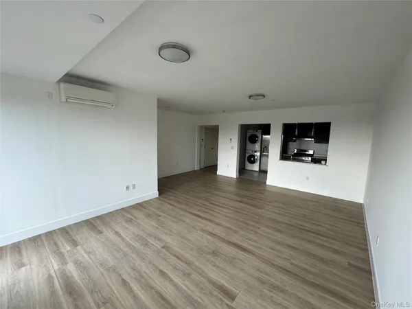 a view of a livingroom with wooden floor and furniture