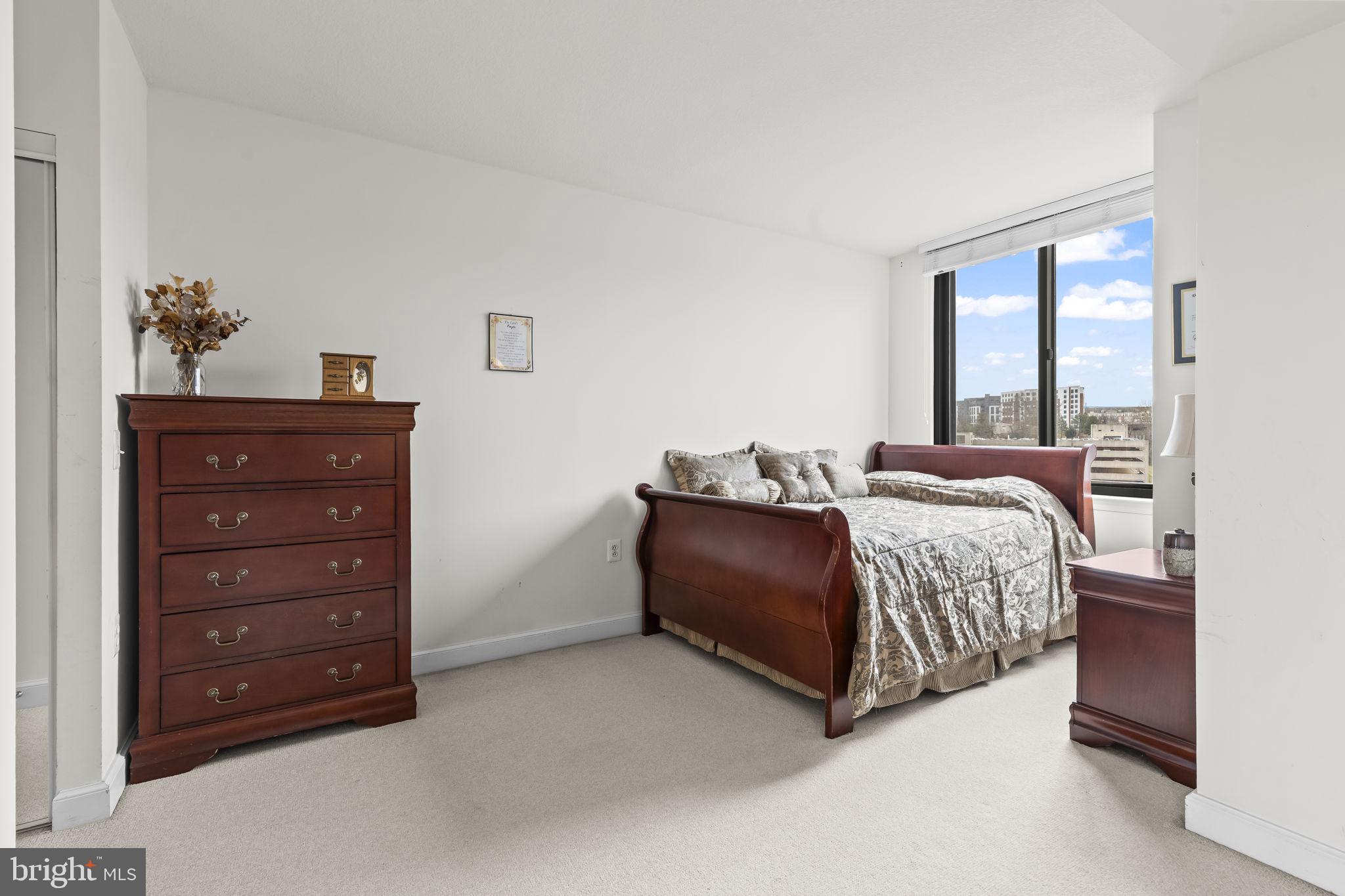 2451 Midtown Avenue, Unit 1413 Alexandria, VA 22303 - Photo 12 of 19 a bedroom with a bed and a dresser