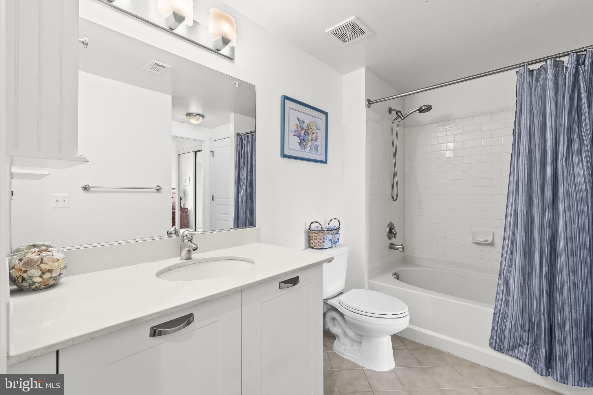 2451 Midtown Avenue, Unit 1413 Alexandria, VA 22303 - Photo 16 of 19 a bathroom with a sink a toilet and shower