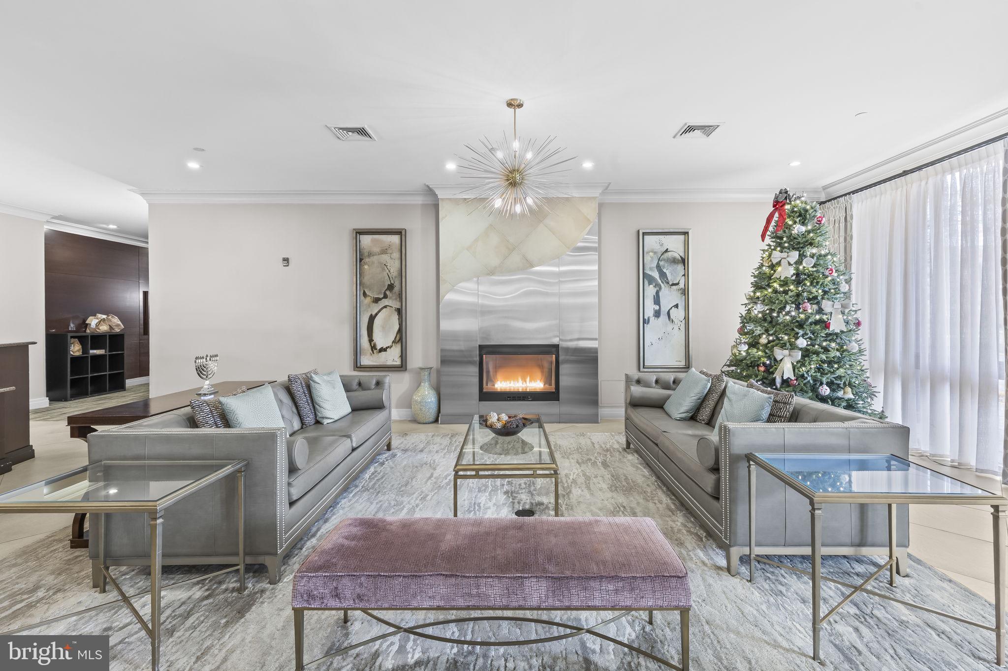 2451 Midtown Avenue, Unit 1413 Alexandria, VA 22303 - Photo 3 of 19 a living room with furniture a chandelier and a fireplace