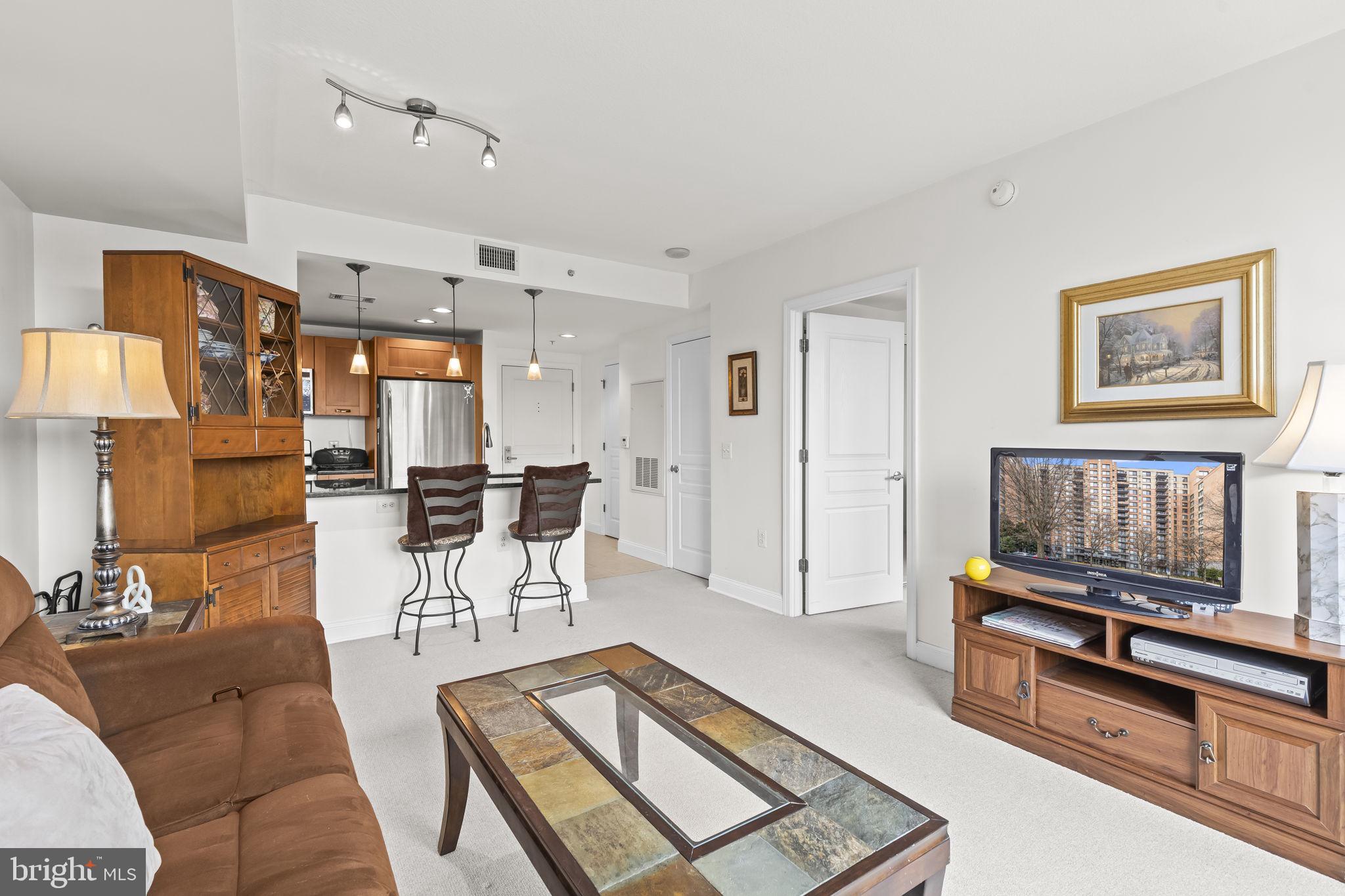 2451 Midtown Avenue, Unit 1413 Alexandria, VA 22303 - Photo 5 of 19 a living room with furniture and a flat screen tv