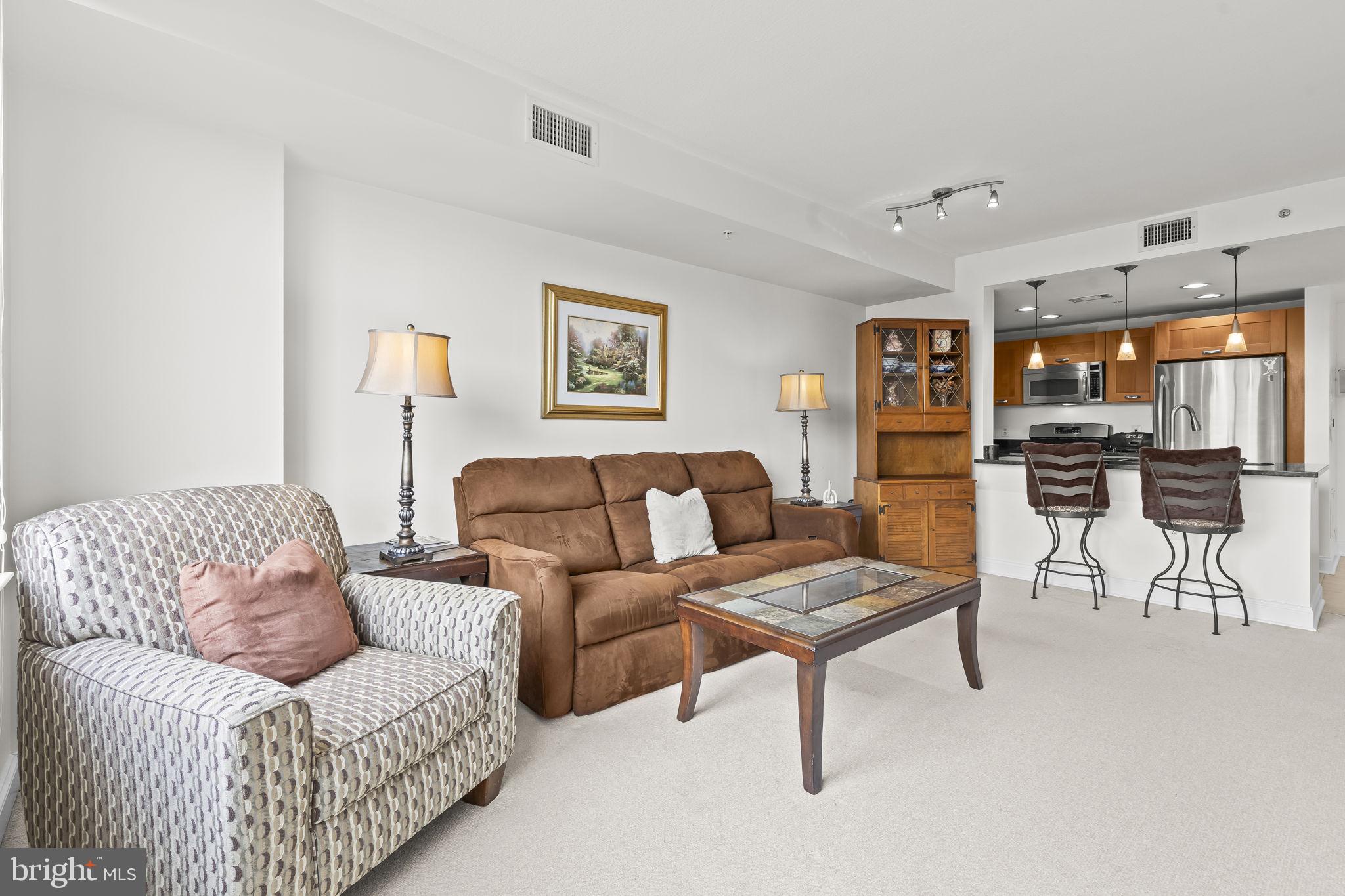 2451 Midtown Avenue, Unit 1413 Alexandria, VA 22303 - Photo 6 of 19 a living room with furniture and a view of kitchen