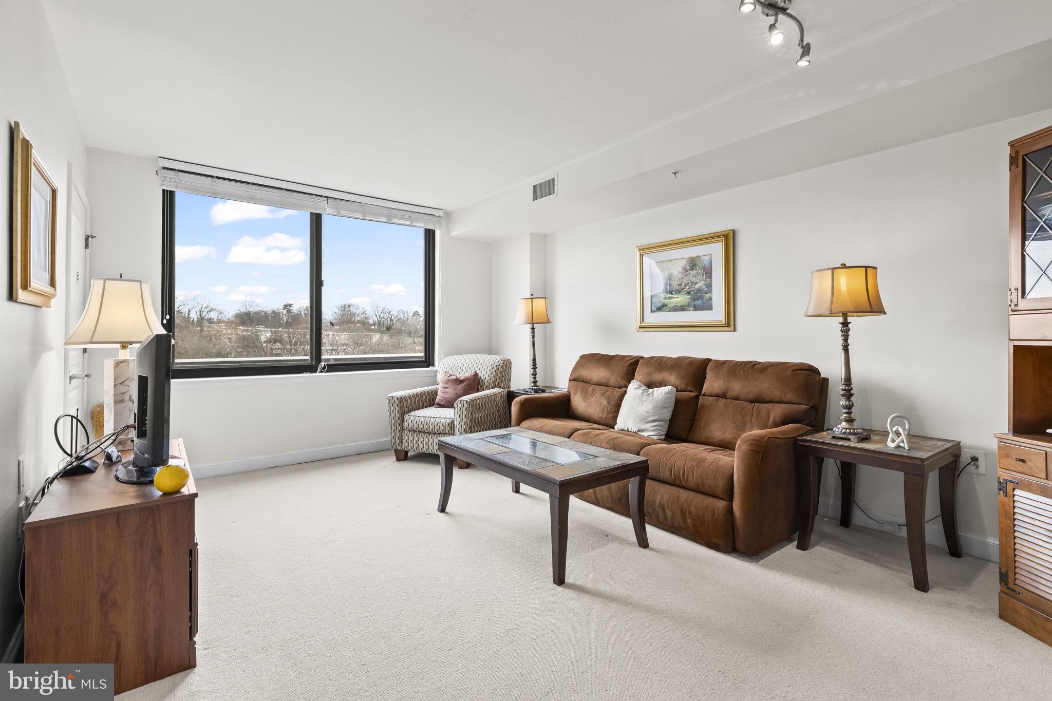 2451 Midtown Avenue, Unit 1413 Alexandria, VA 22303 - Photo 7 of 19 a living room with furniture and a large window