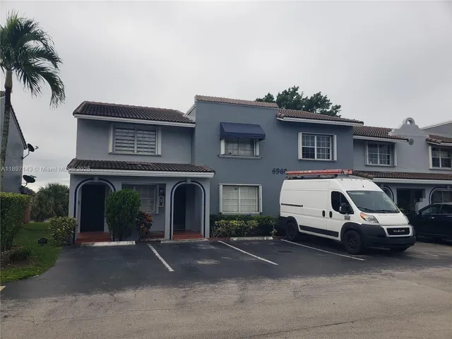 a view of a car parked in front of a house