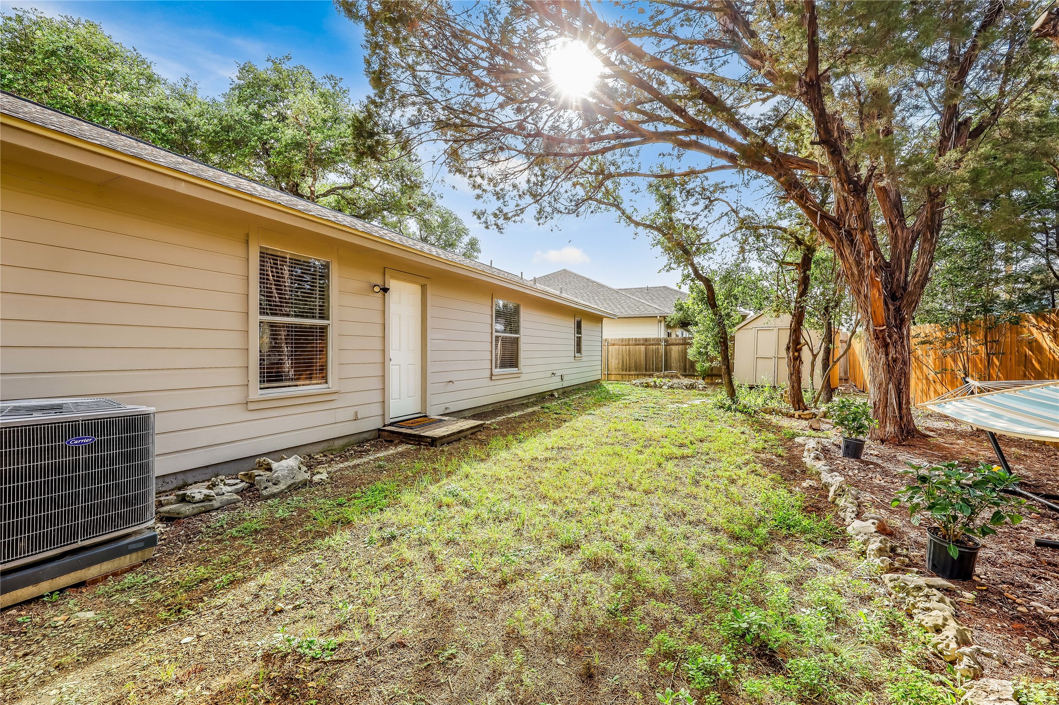 426 Summit Ridge Drive North Point Venture, TX 78645 - Photo 27 of 28 View of yard featuring central AC and a storage shed