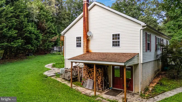 a view of a house with backyard porch and furniture