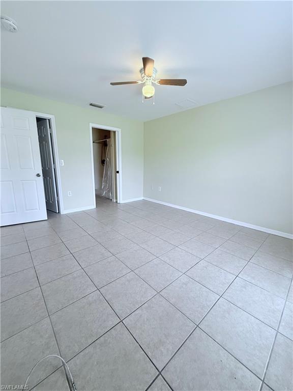 5212 30th Street Southwest Lehigh Acres, FL 33973 - Photo 12 of 15 a view of a livingroom with a ceiling fan and window
