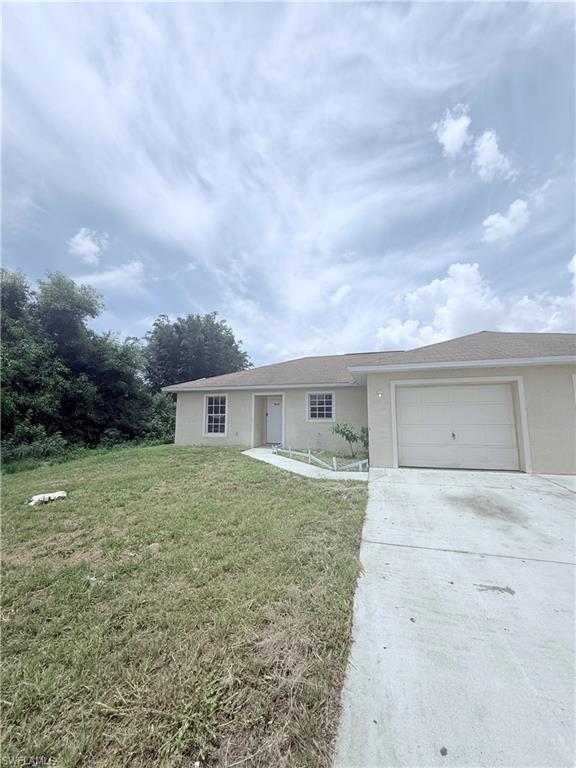 5212 30th Street Southwest Lehigh Acres, FL 33973 - Photo 2 of 15 front view of house with a yard