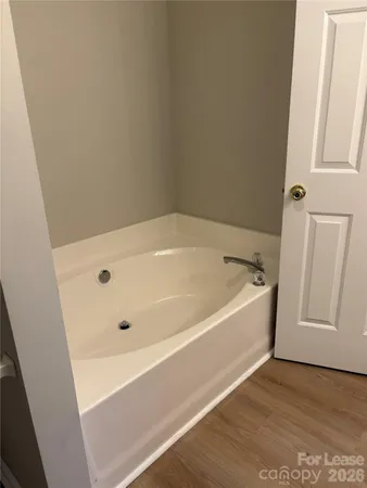 a bathroom with a tub and a shower