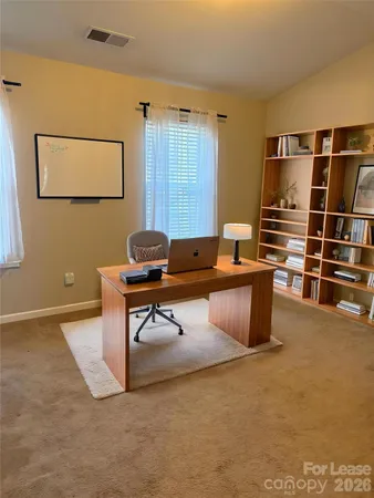 a room with furniture pool table and window