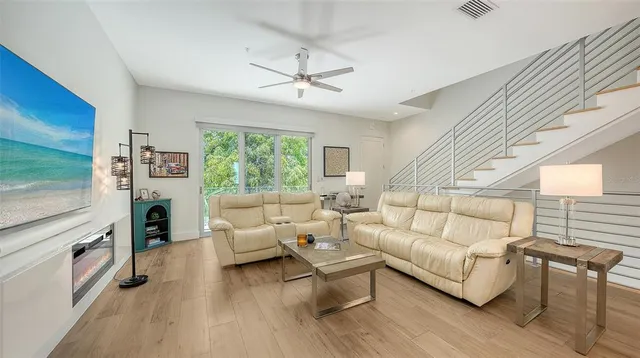 a living room with furniture a chandelier and a chandelier