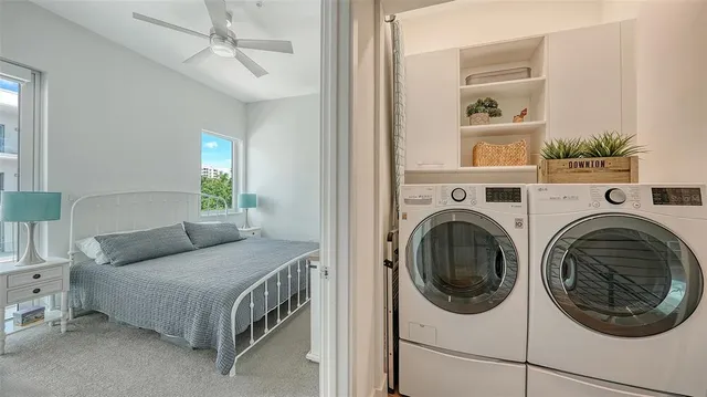 a living room with furniture and a dining table with rug
