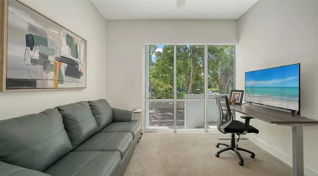 a view of a blue building next to a yard