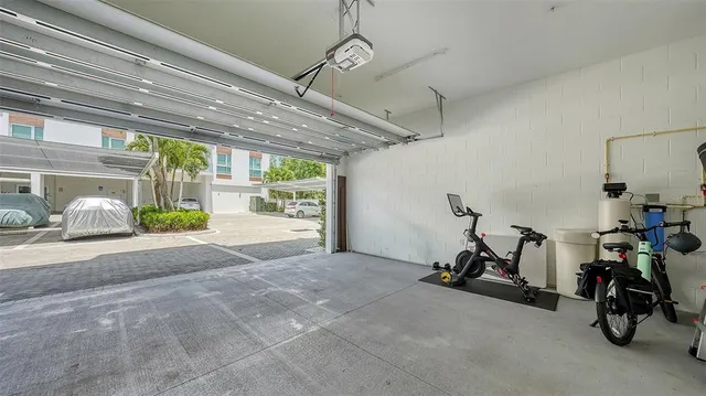 a front view of a house with a yard and potted plants