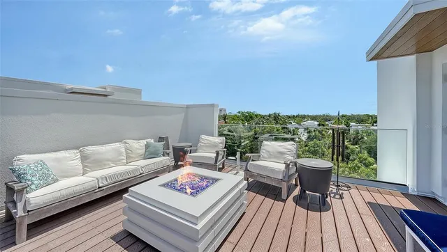 a view of a dining room with furniture a chandelier and wooden floor