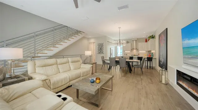 a kitchen with a sink a stove and chairs