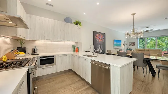 a living room with furniture a fireplace and a chandelier