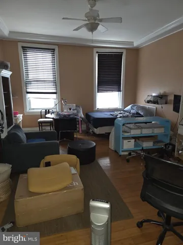 a living room with furniture a window and a flat screen tv