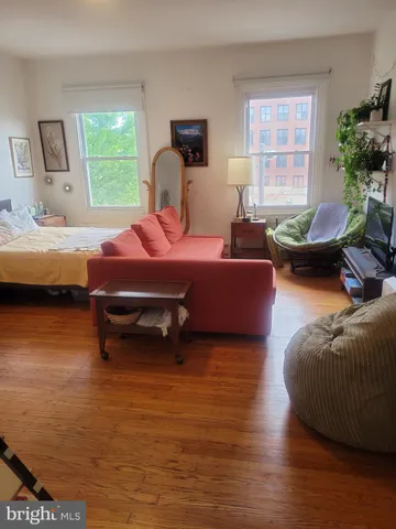 a bedroom with furniture and a window