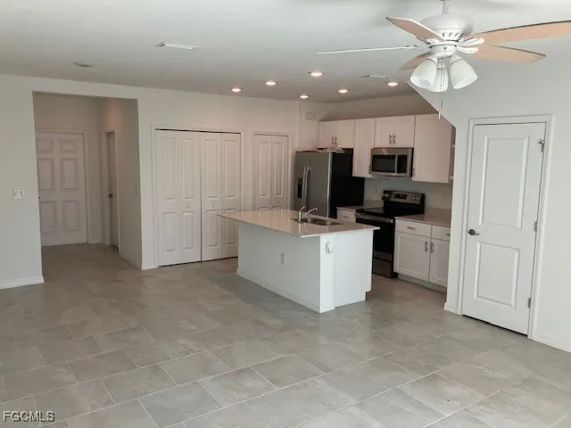a view of a kitchen with electric appliances