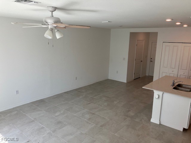 14309 Oviedo Place Fort Myers, FL 33905 - Photo 4 of 30 an empty room with a mirror and a fan