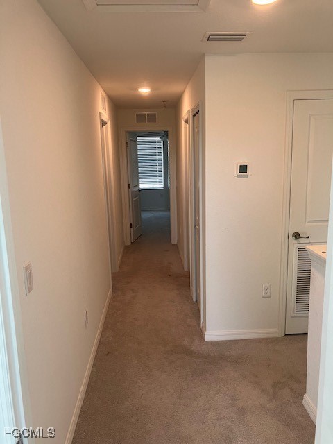 14309 Oviedo Place Fort Myers, FL 33905 - Photo 7 of 30 a view of hallway with closet and a white door
