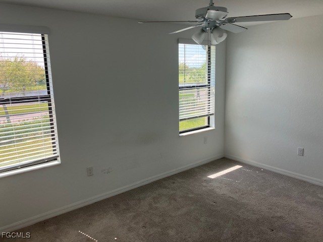 14309 Oviedo Place Fort Myers, FL 33905 - Photo 8 of 30 an empty room with windows and fan