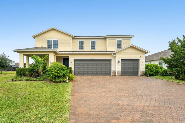 a front view of a house with a yard and garage