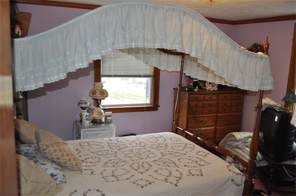 23 Clancy Road Boston, MA 02124 - Photo 5 of 11 a bedroom with a bed and a dresser