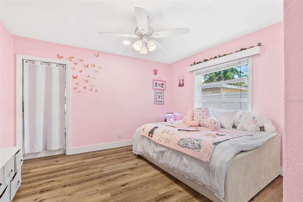 2215 Hibiscus Street Sarasota, FL 34239 - Photo 26 of 69 a bedroom with a bed and a chandelier