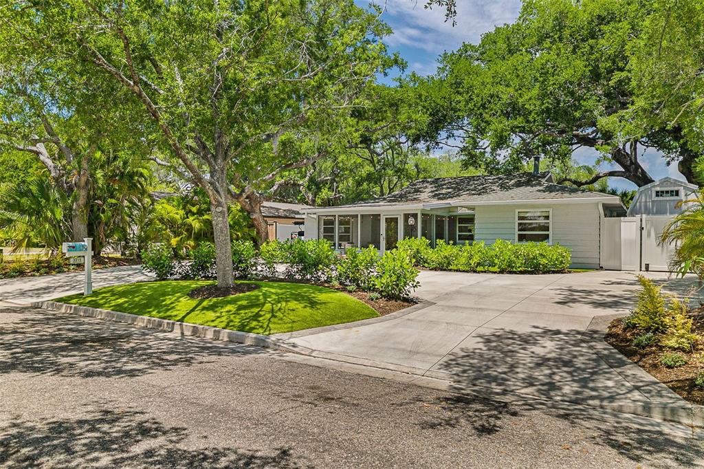 2215 Hibiscus Street Sarasota, FL 34239 - Photo 5 of 69 a front view of a house with a yard and a garden