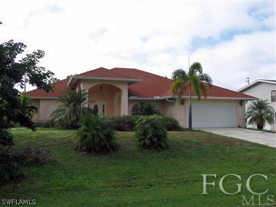 10683 Holly Road Bokeelia, FL 33922 - Photo 1 of 10 a front view of house with garden