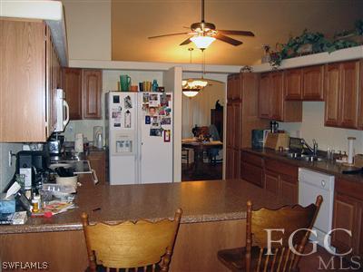 10683 Holly Road Bokeelia, FL 33922 - Photo 2 of 10 a large kitchen with cabinets