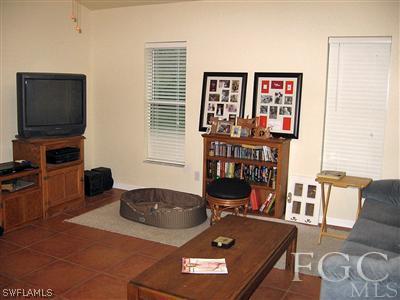 10683 Holly Road Bokeelia, FL 33922 - Photo 3 of 10 a living room with furniture and a flat screen tv
