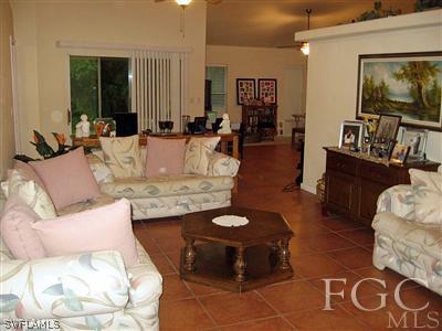 10683 Holly Road Bokeelia, FL 33922 - Photo 4 of 10 a living room with furniture and a flat screen tv